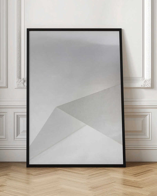 Minimalist abstract art of folded paper creating clean lines and geometric shapes in shades of grey and white.