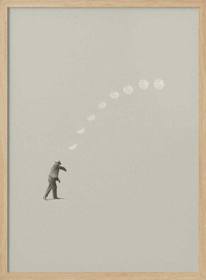 A man tosses the phases of the moon into the sky in a surreal, minimalist art piece.
