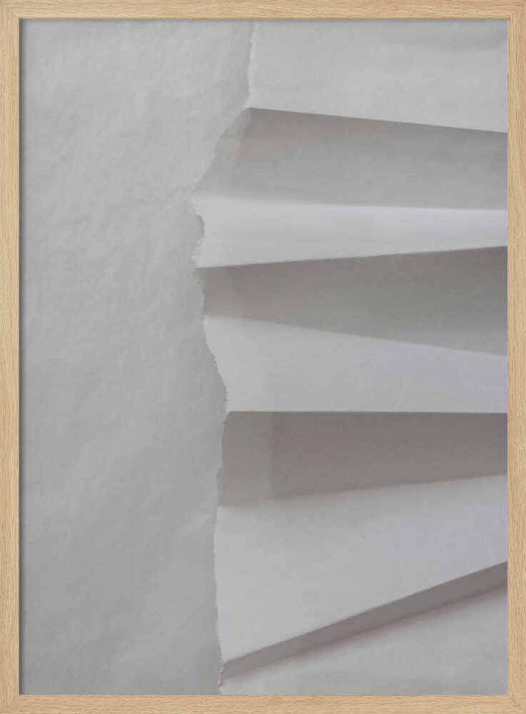 A minimalist composition of folded and torn white paper, showcasing geometric forms and shadows in a black frame.