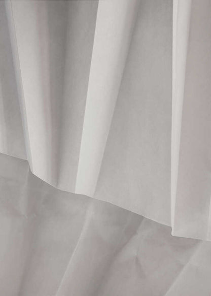 Abstract art print of folded white fabric or paper creating soft lines and deep shadows.