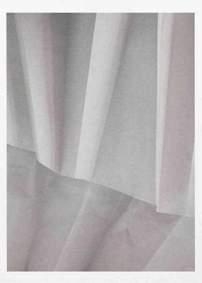 Abstract art print of folded white fabric or paper creating soft lines and deep shadows.