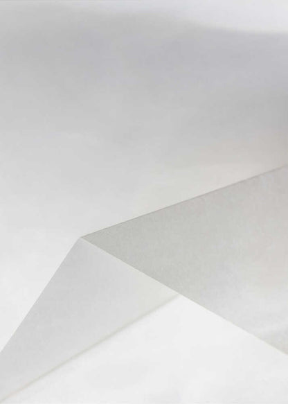 Minimalist abstract art of folded paper creating clean lines and geometric shapes in shades of grey and white.