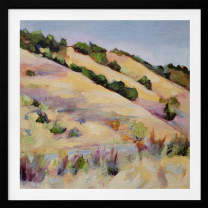 An impressionist oil painting of golden, rolling hills dotted with green shrubs under a pale blue sky, framed in light wood.