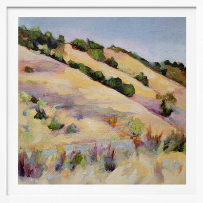 An impressionist oil painting of golden, rolling hills dotted with green shrubs under a pale blue sky, framed in light wood.