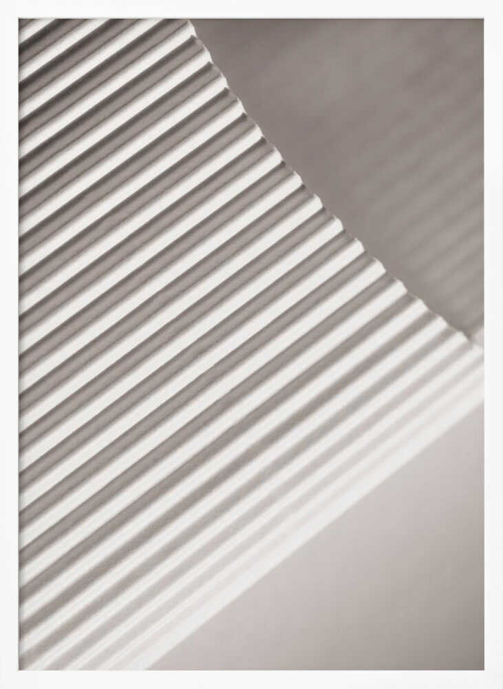 Abstract photograph of a ribbed surface with diagonal lines created by light and shadow, minimalist wall art.