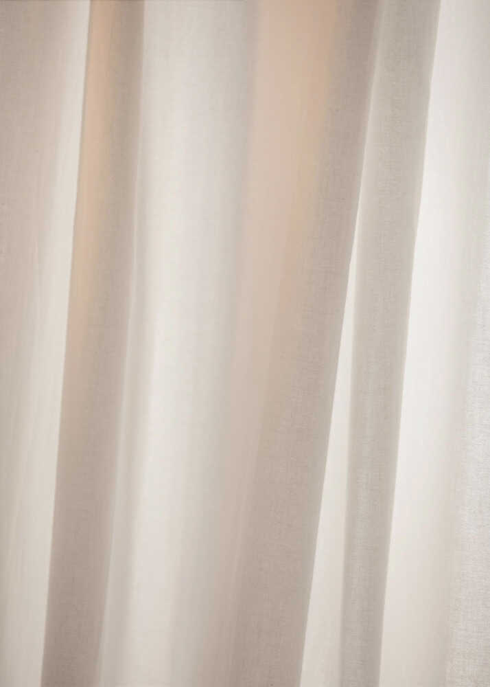 Abstract photo of light beige fabric with soft, flowing folds creating gentle shadows.