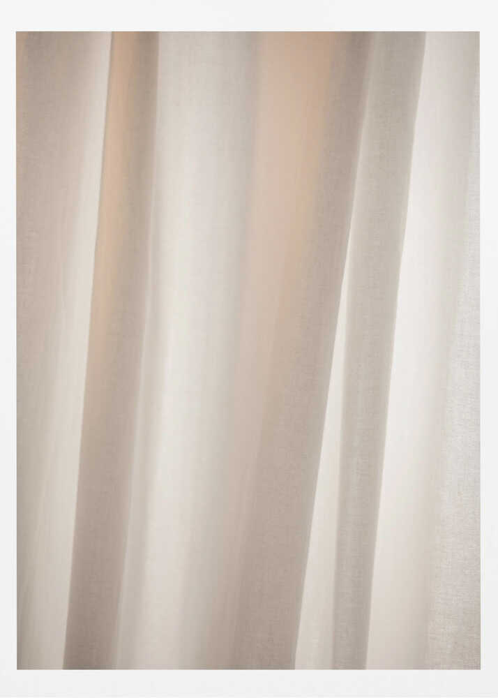 Abstract photo of light beige fabric with soft, flowing folds creating gentle shadows.