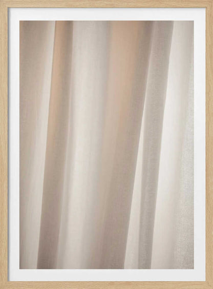 Abstract photo of light beige fabric with soft, flowing folds creating gentle shadows.