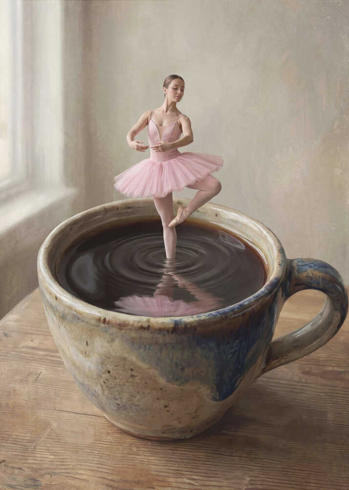 A small ballerina in a pink tutu dances gracefully in a large cup of black coffee.