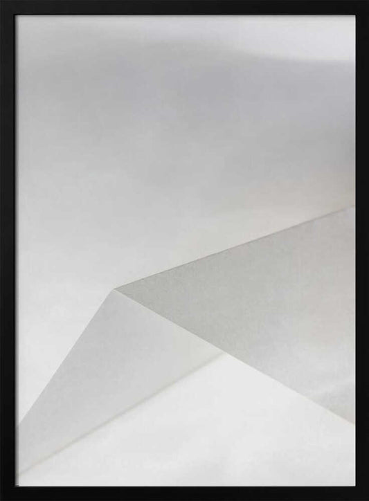 Minimalist abstract art of folded paper creating clean lines and geometric shapes in shades of grey and white.