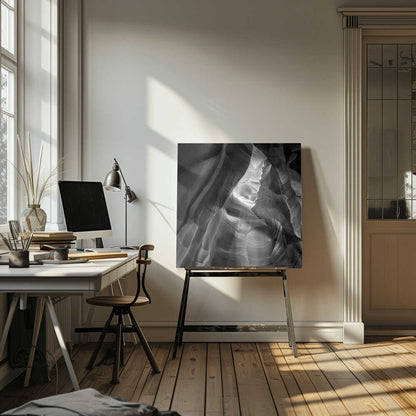 Black and white photo of light in a narrow slot canyon, highlighting smooth, layered rock formations. Nature wall art.