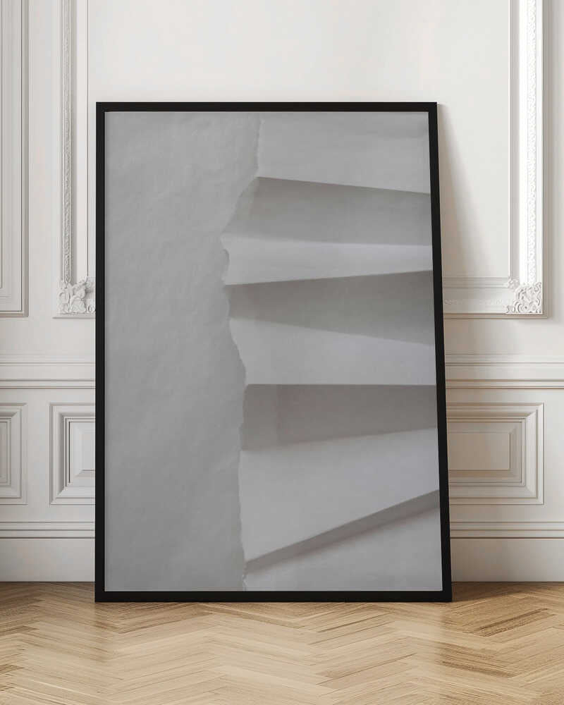 A minimalist composition of folded and torn white paper, showcasing geometric forms and shadows in a black frame.