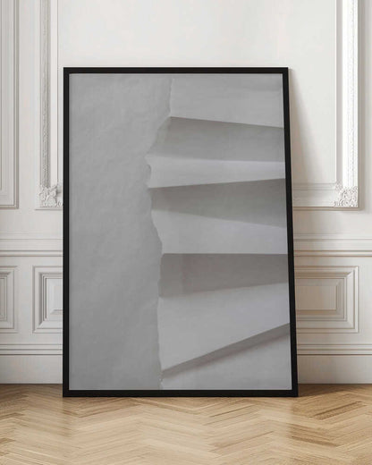 A minimalist composition of folded and torn white paper, showcasing geometric forms and shadows in a black frame.
