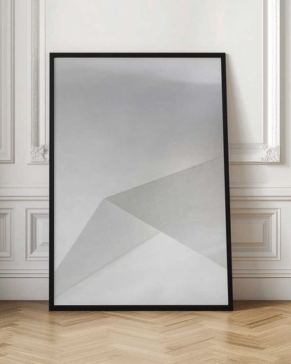 Minimalist abstract art of folded paper creating clean lines and geometric shapes in shades of grey and white.