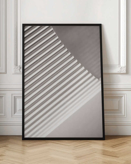 Abstract photograph of a ribbed surface with diagonal lines created by light and shadow, minimalist wall art.