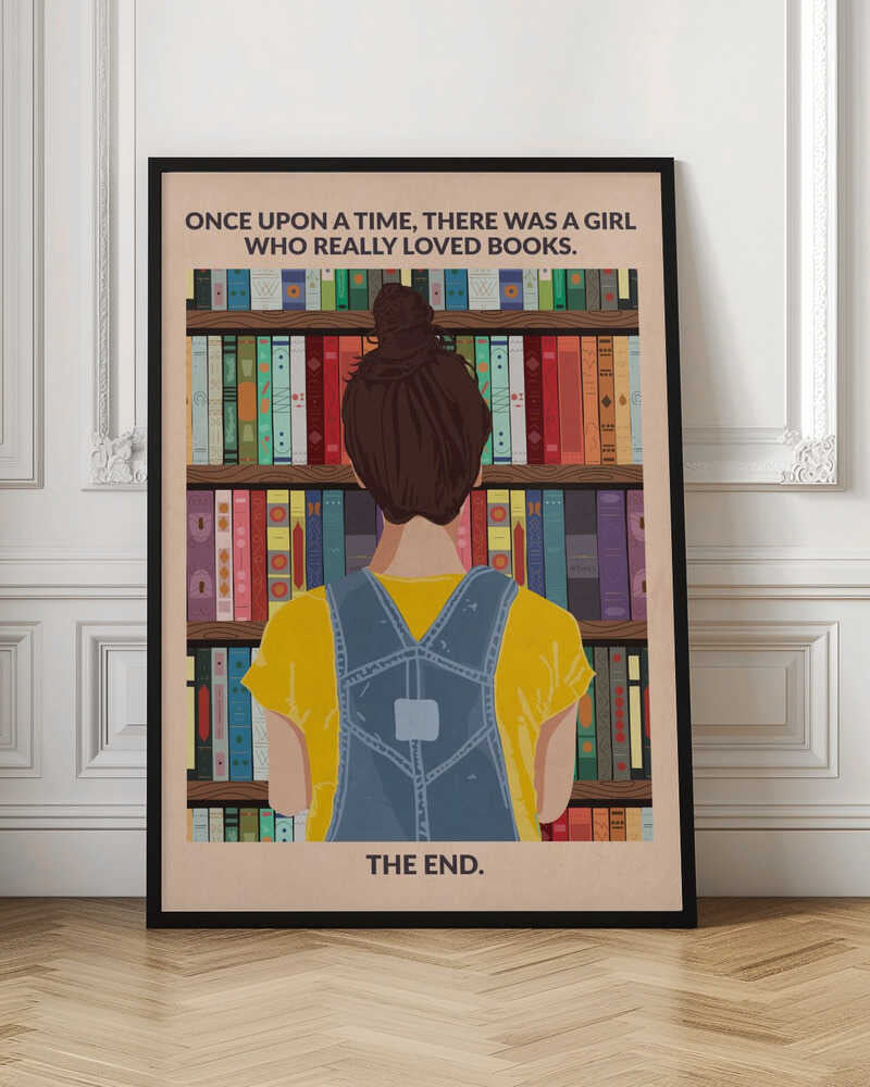 An illustrated poster with a vintage feel, showing the back of a girl with brown hair in a bun, wearing a yellow shirt and blue overalls. She is looking at a tall bookshelf filled with colorful books. Text at the top reads 'ONCE UPON A TIME, THERE WAS A GIRL WHO REALLY LOVED BOOKS.' and text at the bottom reads 'THE END.' The poster is enclosed in a black frame. Artwork