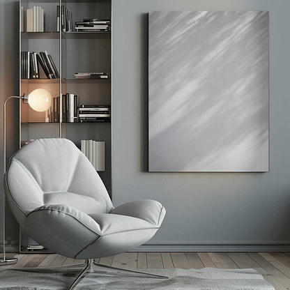 Diagonal leaf shadows cast on a white textured wall, creating a minimalist black and white art piece.