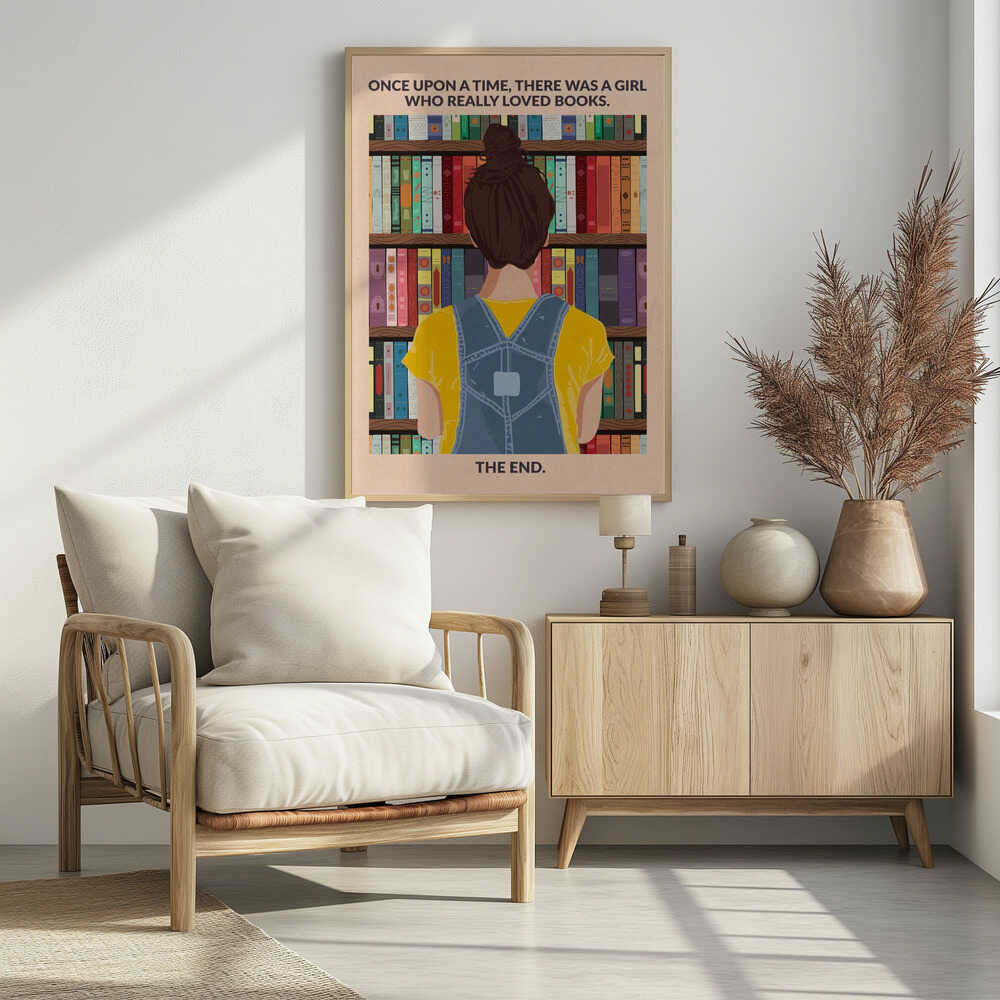 An illustrated poster with a vintage feel, showing the back of a girl with brown hair in a bun, wearing a yellow shirt and blue overalls. She is looking at a tall bookshelf filled with colorful books. Text at the top reads 'ONCE UPON A TIME, THERE WAS A GIRL WHO REALLY LOVED BOOKS.' and text at the bottom reads 'THE END.' The poster is enclosed in a black frame. Artwork
